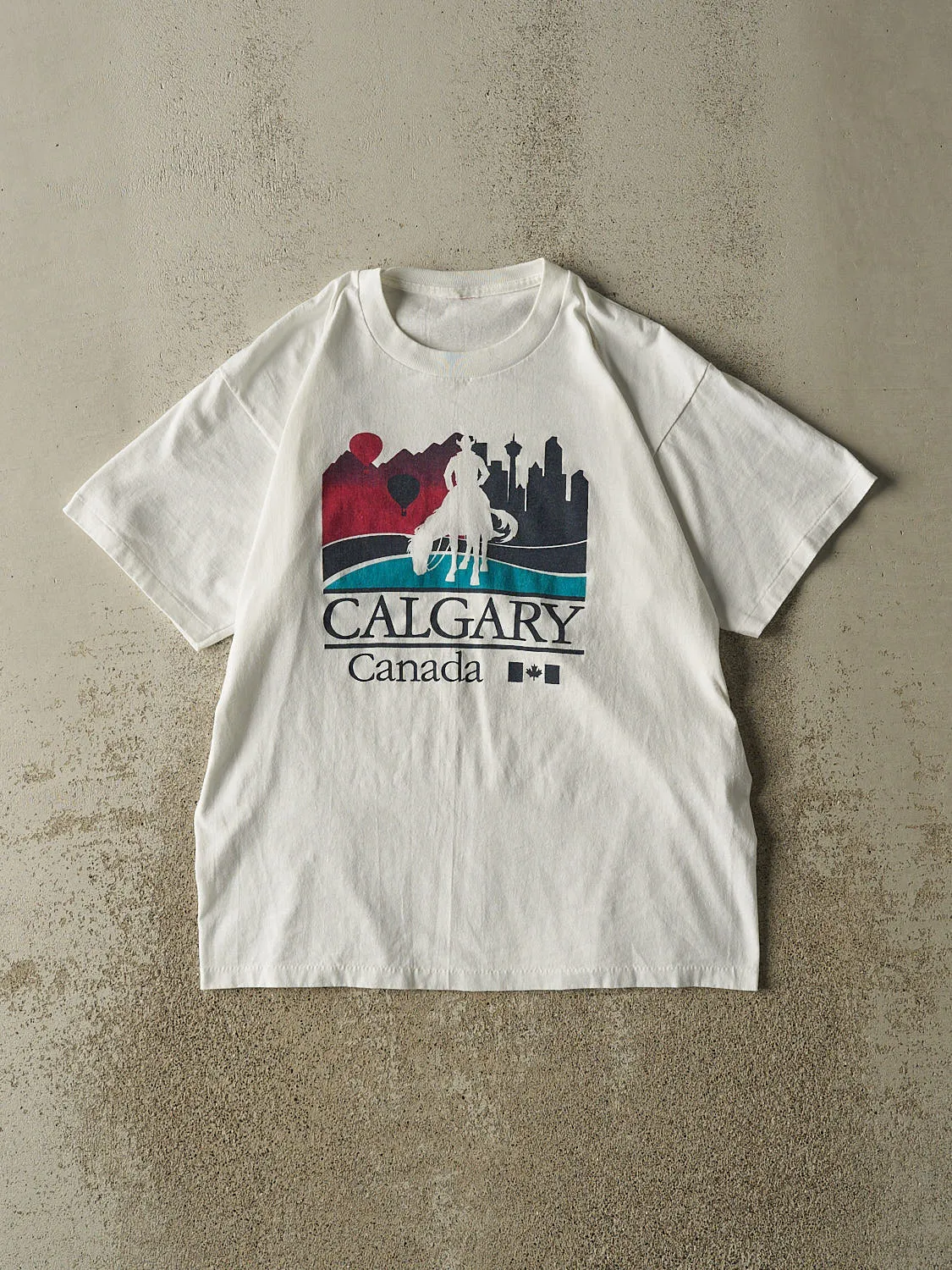 Vintage 90s White Calgary Single Stitch Tee (M) sold by Rebalance Vintage