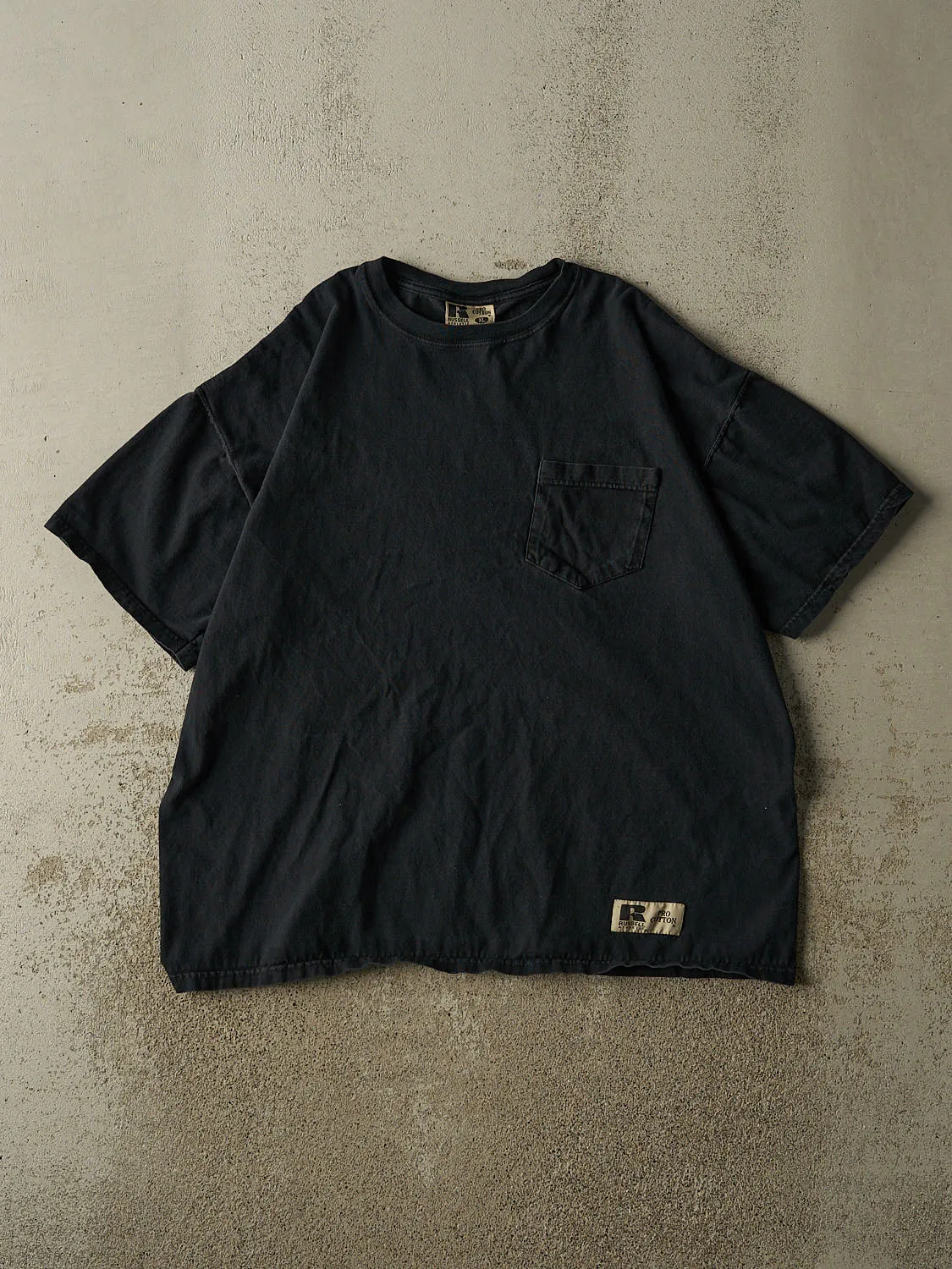 Vintage 90s Faded Black Russell Athletic Pocket Tee (L/XL) sold by Rebalance Vintage