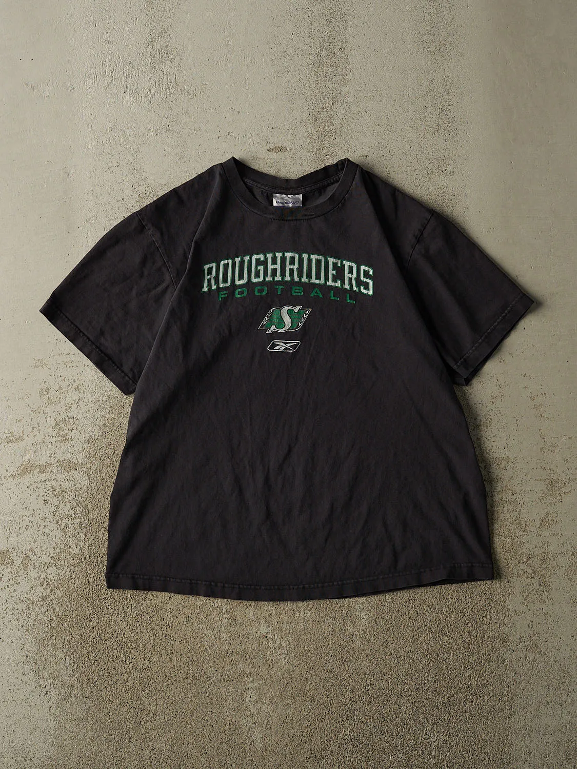 Vintage 90s Faded Black Saskatchewan Rough Riders Tee (M/L) sold by Rebalance Vintage