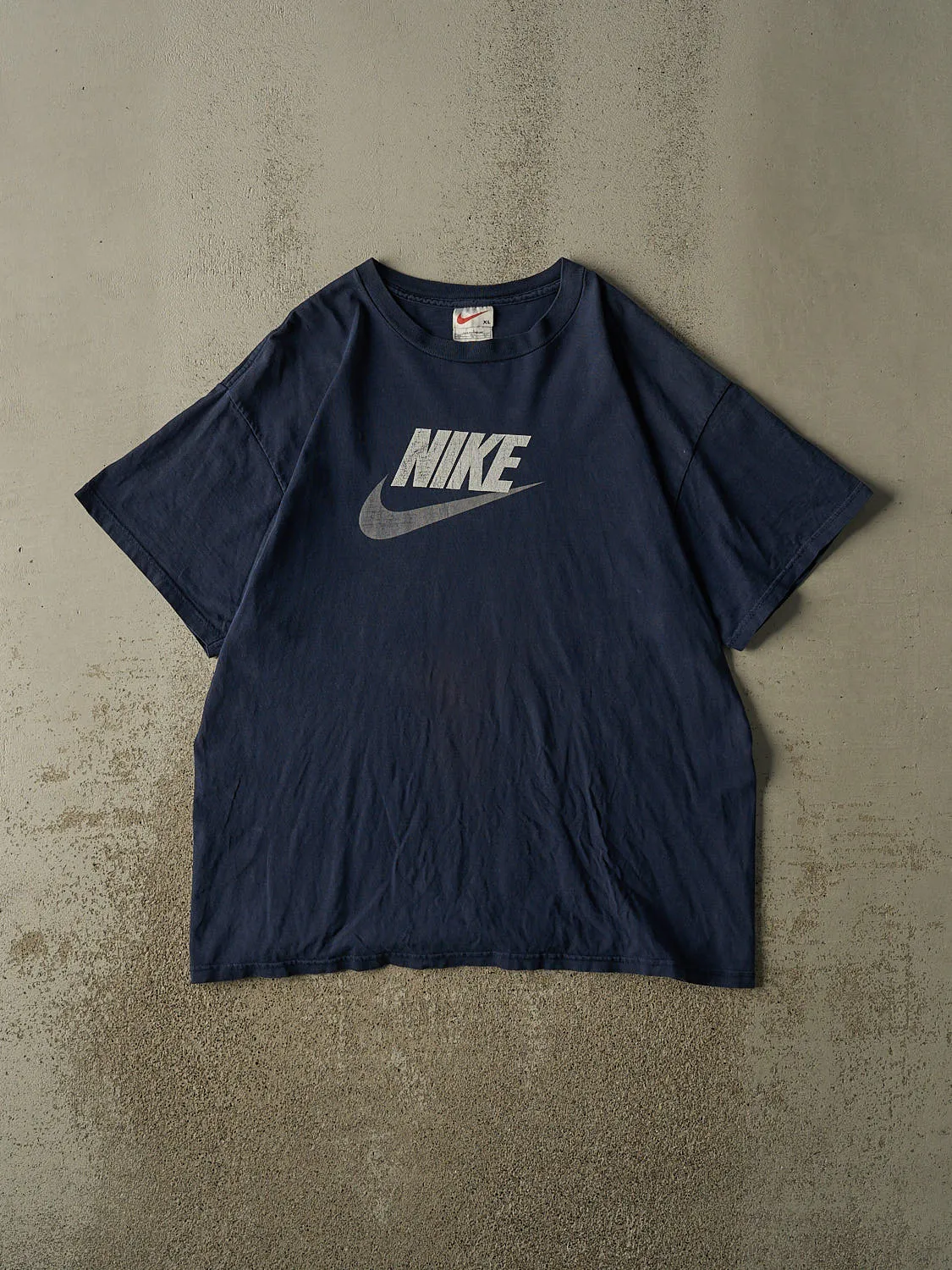 Vintage 90s Navy Blue Nike Logo Tee (XL/XXL) sold by Rebalance Vintage