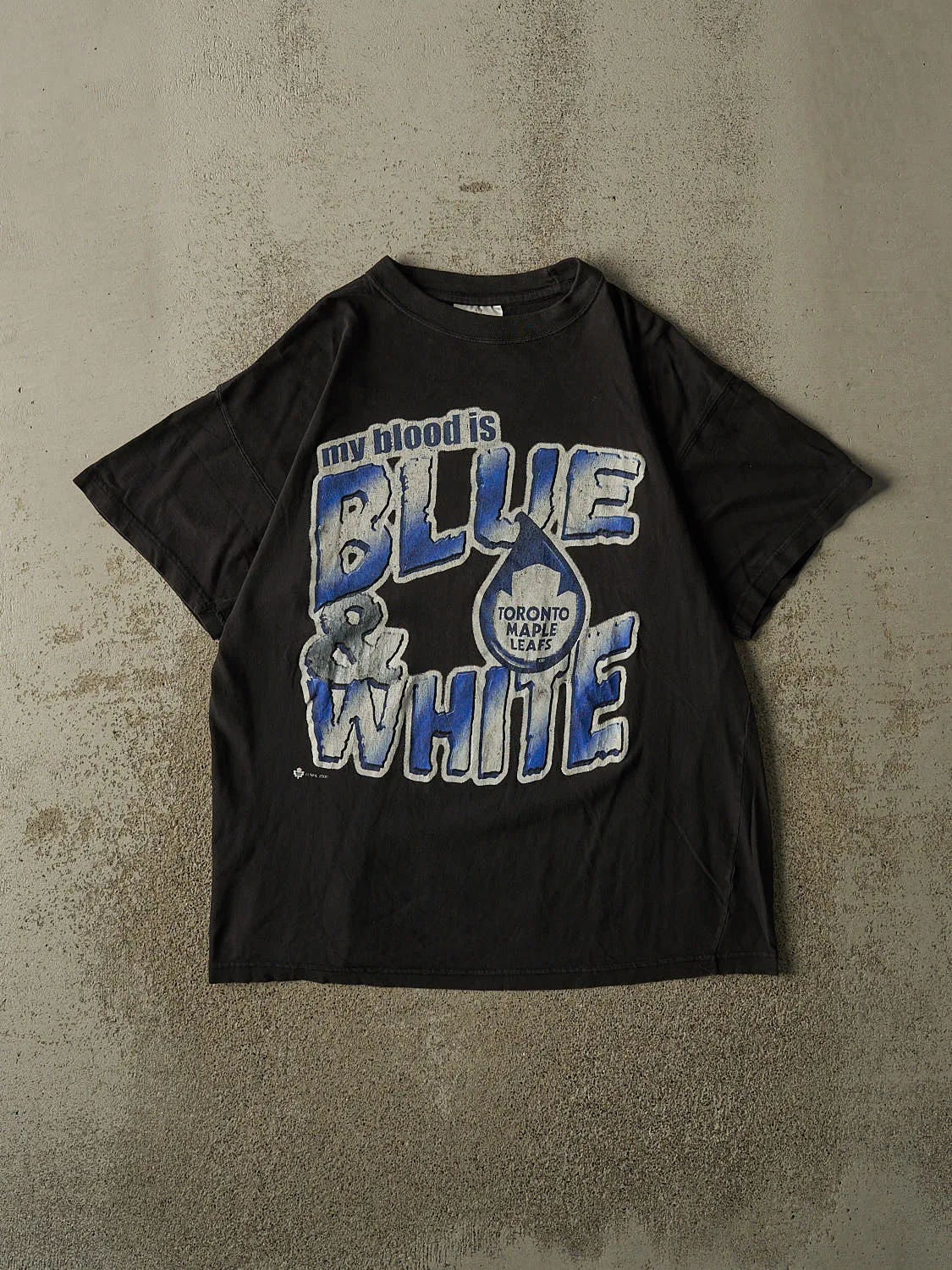 Vintage 00' Black Toronto Maple Leafs "Blue & White" Slogan Tee (L) sold by Rebalance Vintage