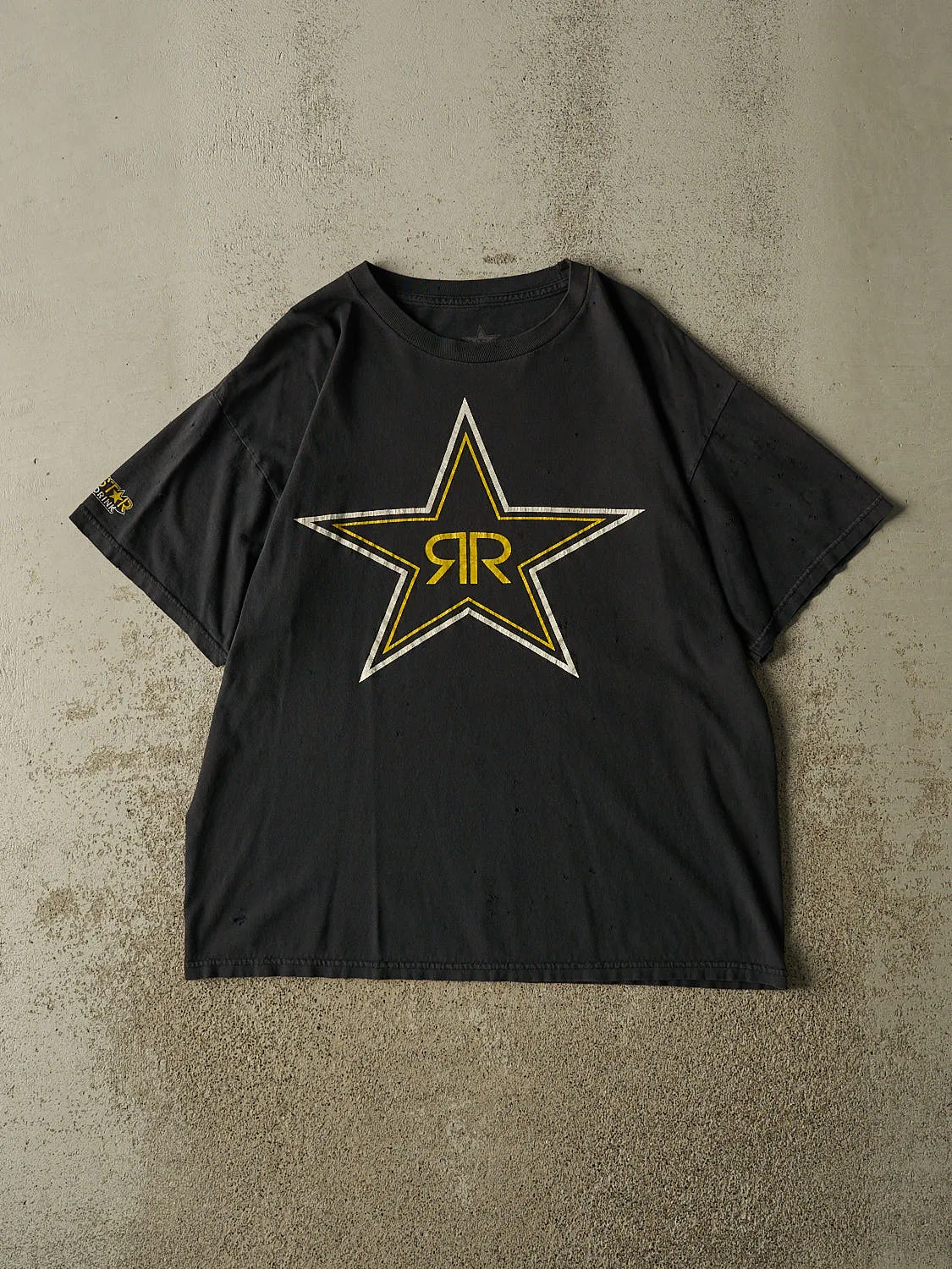 Vintage Y2K Faded Black Rockstar Logo Tee (L/XL) sold by Rebalance Vintage