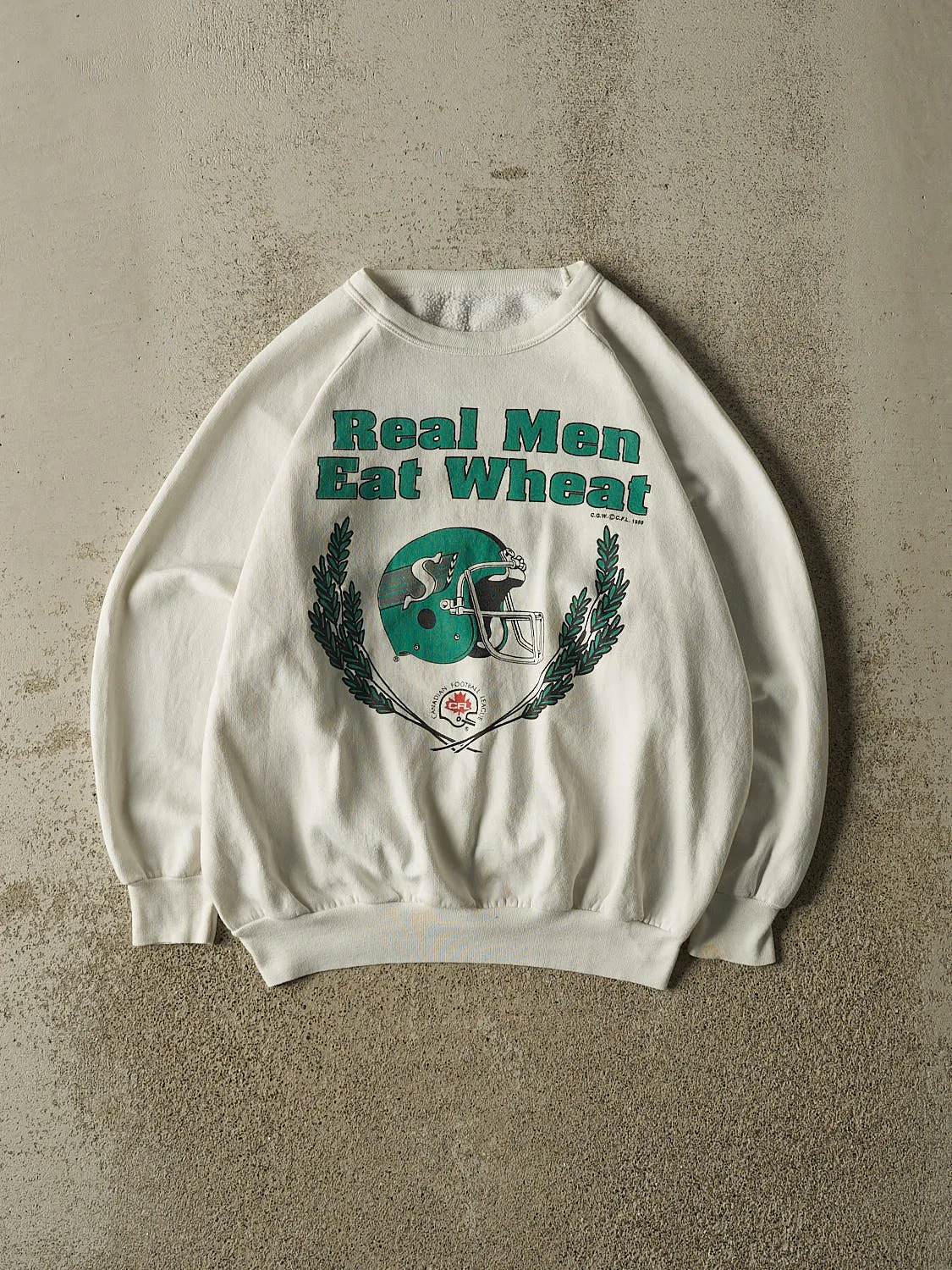 Vintage 89' White Saskatchewan Roughriders "Real Men Eat Wheat" Crewneck (S) sold by Rebalance Vintage