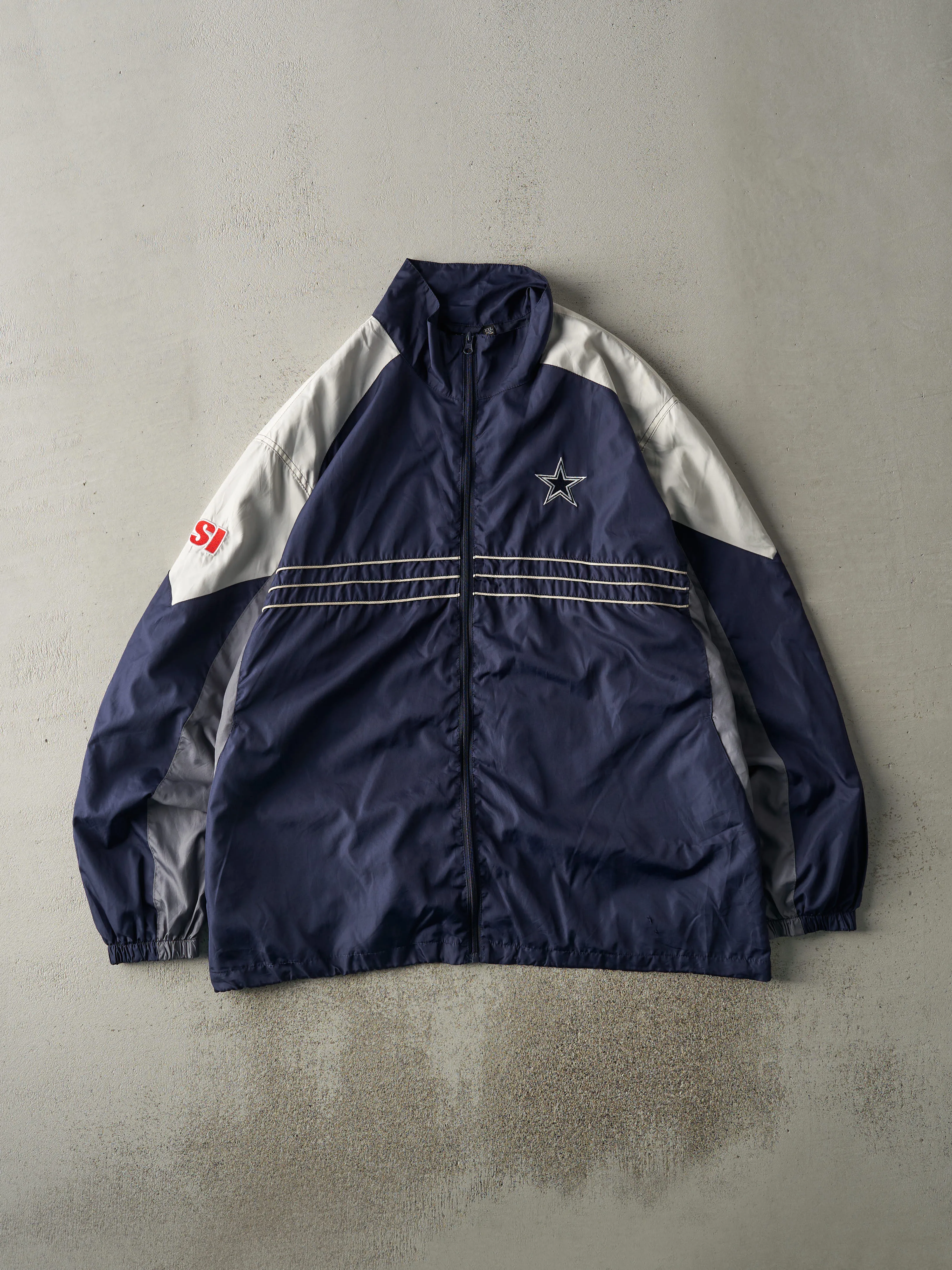 Vintage 90s Navy Blue & Grey Dallas Cowboys Windbreaker Jacket (XL) sold by Rebalance Vintage