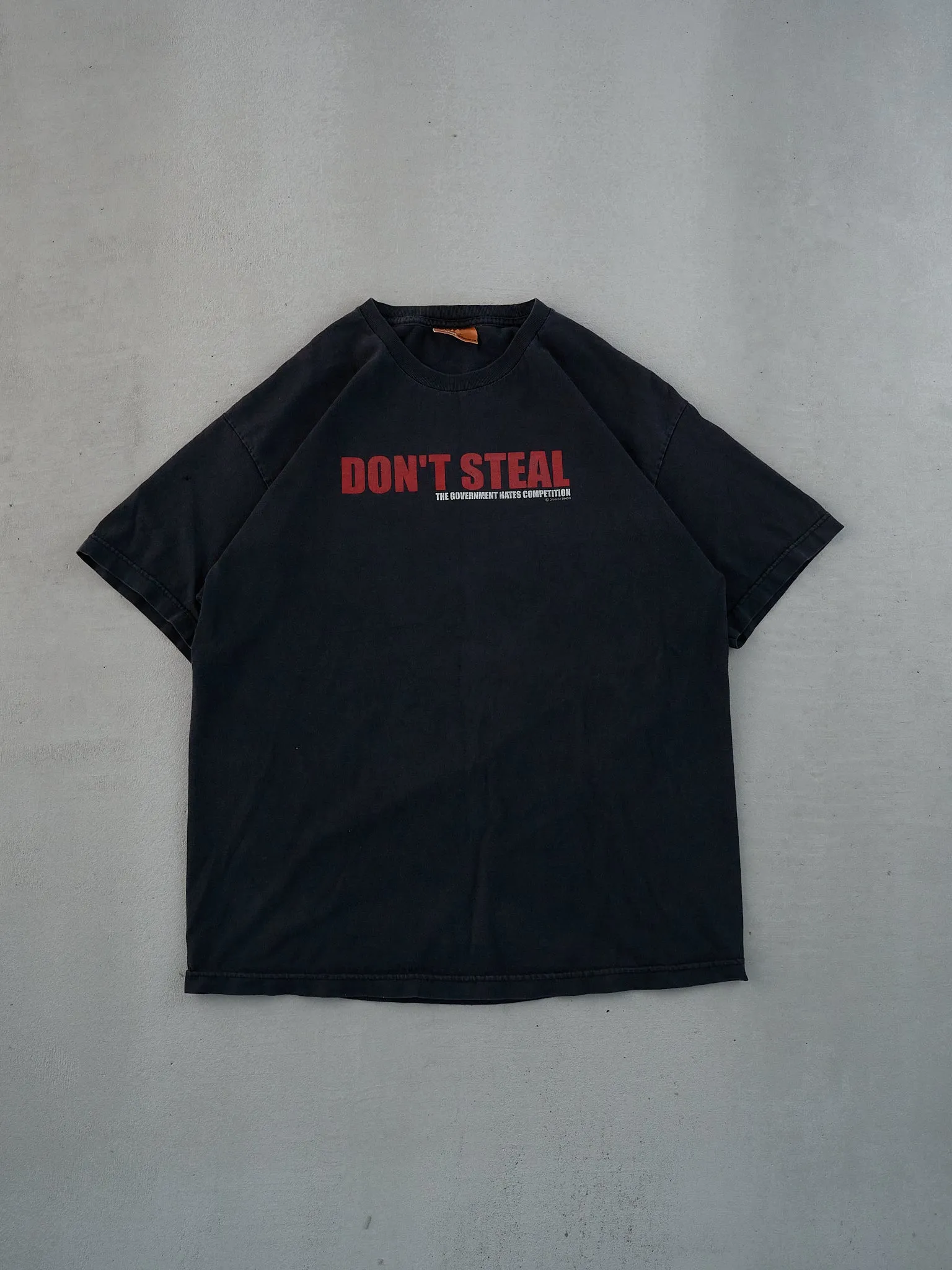 Vintage 90s Black "Don't Steal, the government hates competition" Tee (M) sold by Rebalance Vintage