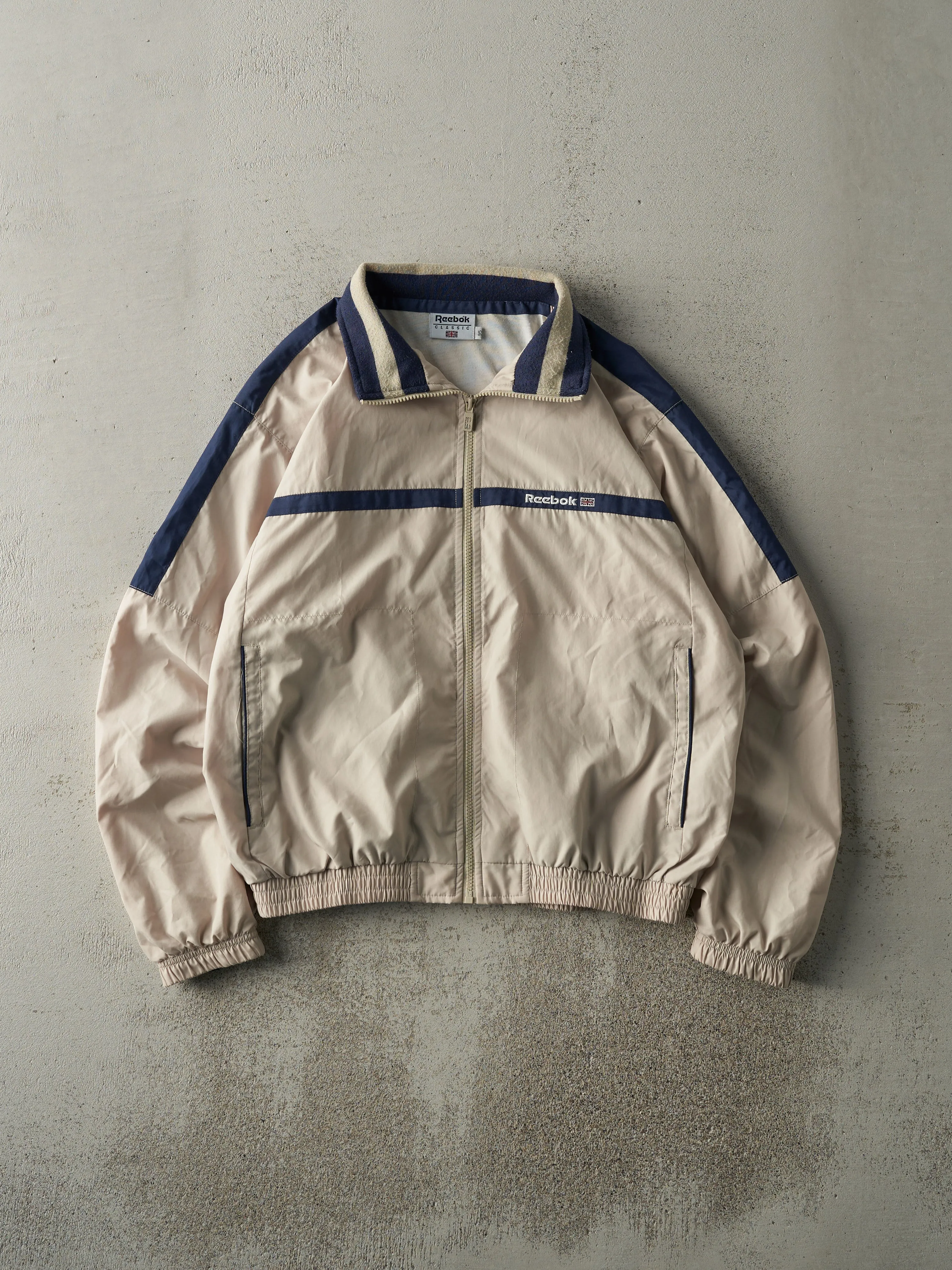 Vintage 90s Beige & Navy Reebok Windbreaker Jacket (M) sold by Rebalance Vintage