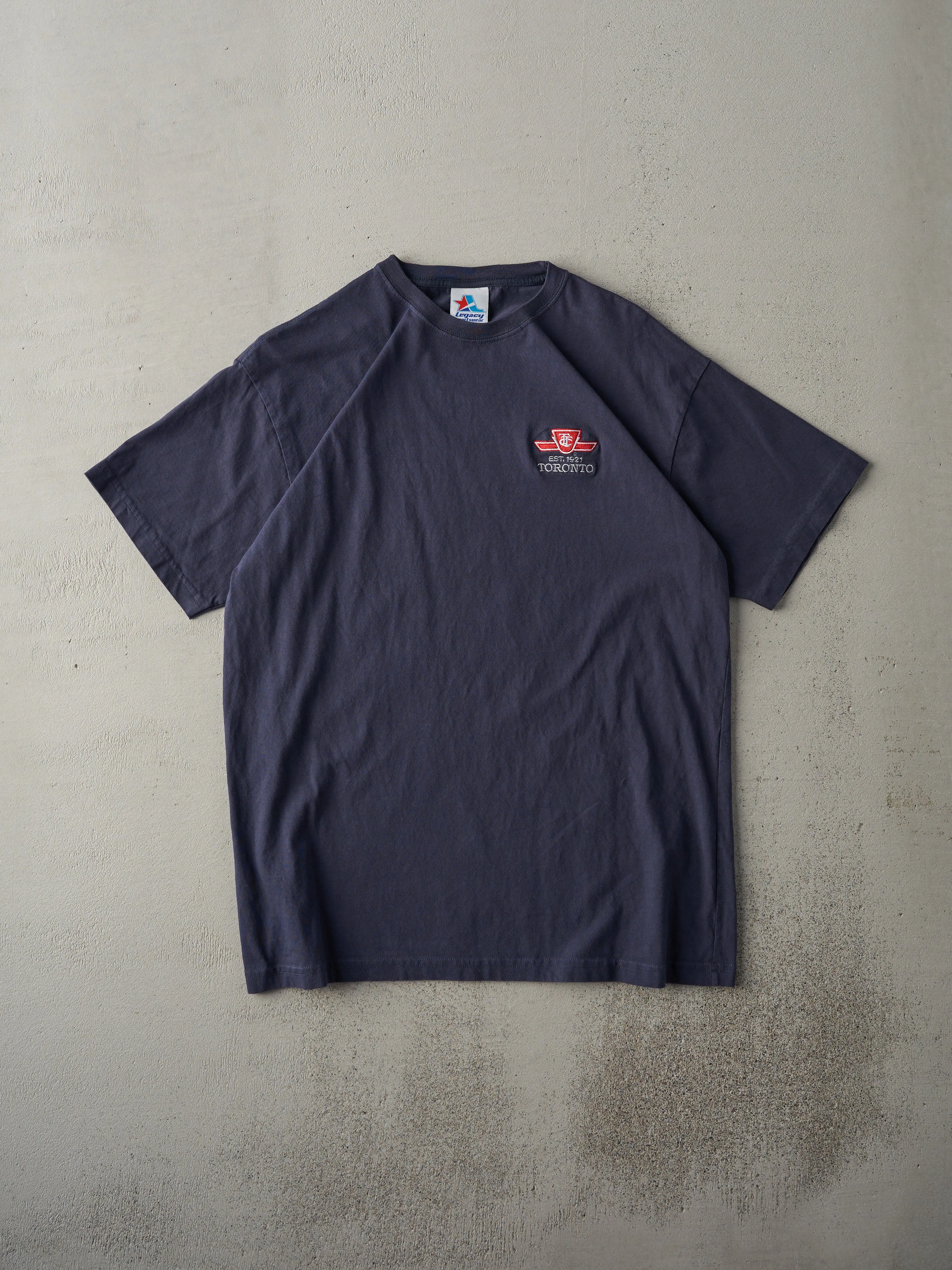 Vintage 90s Navy Blue TTC Embroidered Logo Tee (M) sold by Rebalance Vintage