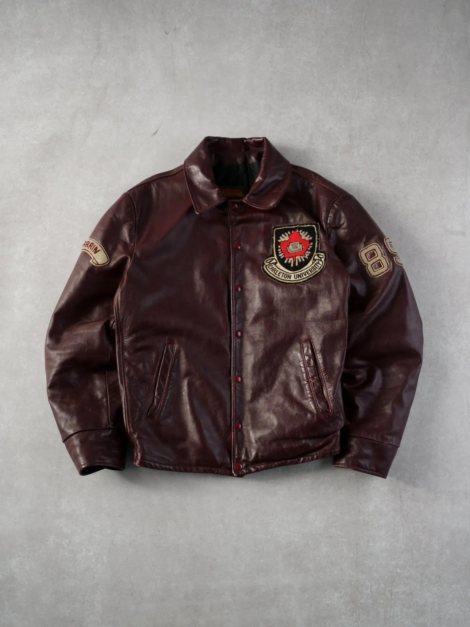 Vintage 89' Maroon Carleton University Emblem Collared Leather Jacket (M/L) sold by Rebalance Vintage