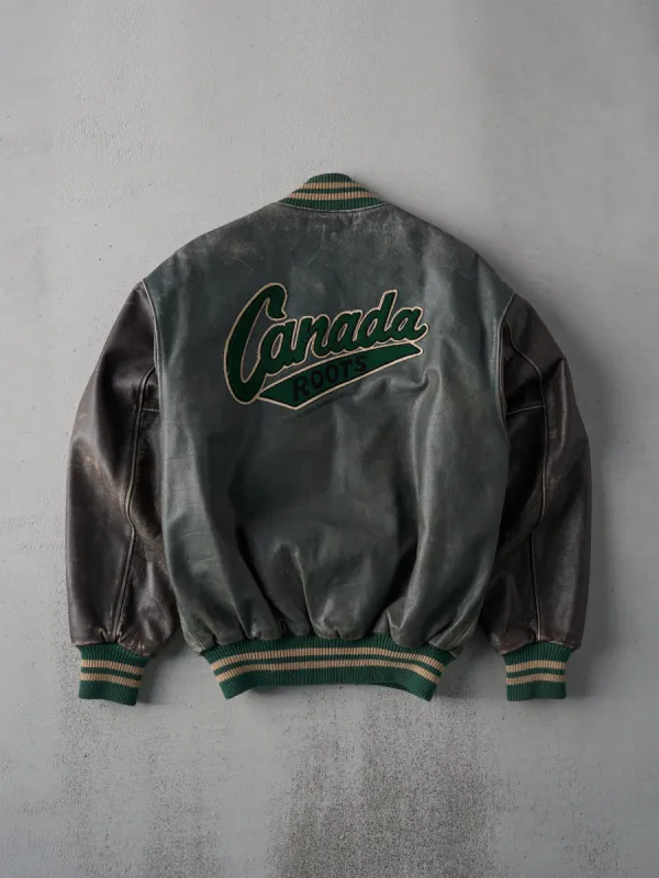 Vintage 90s Green and Brown Roots Leather Varsity Jacket (S/M) sold by Rebalance Vintage