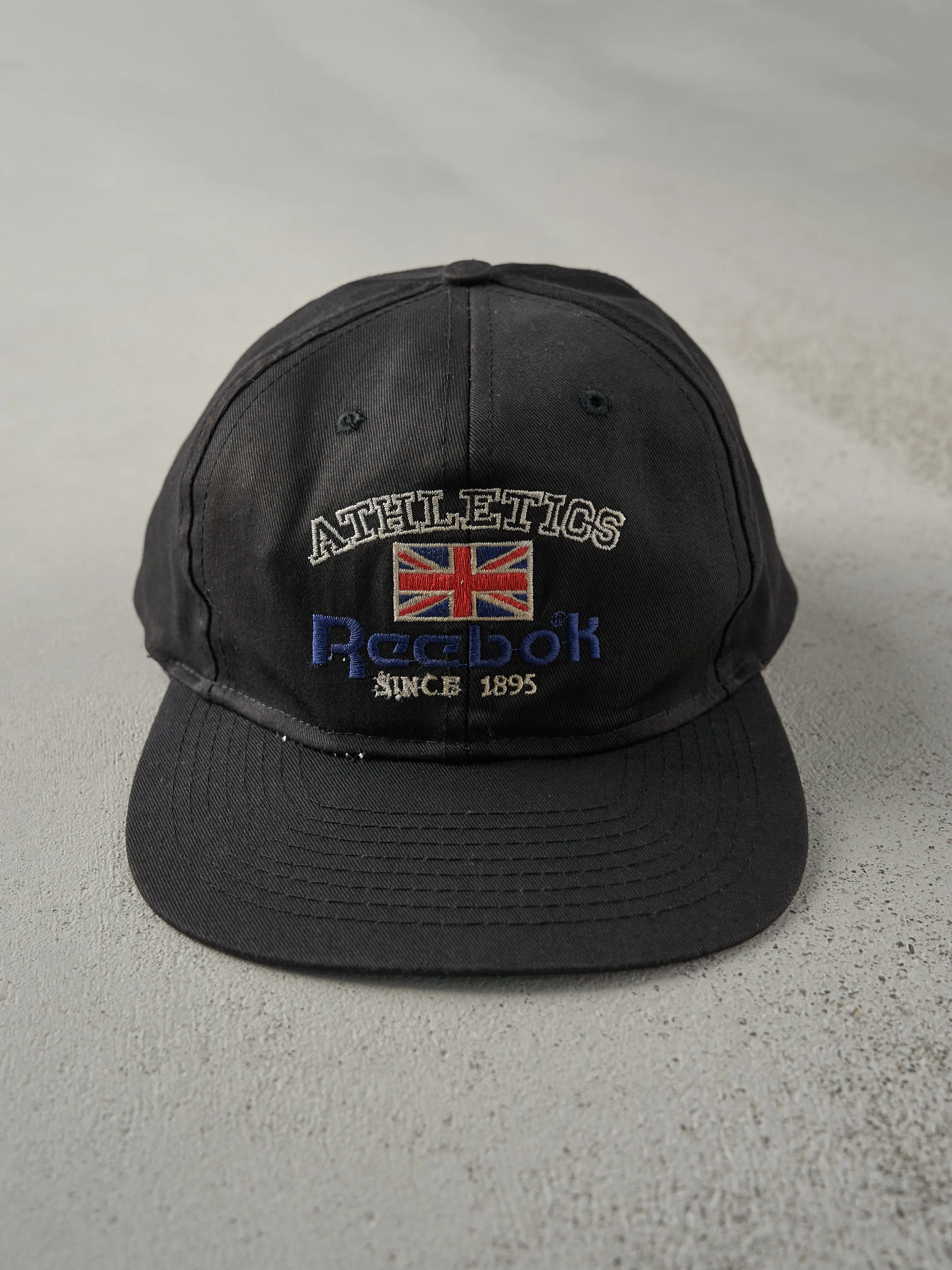 Vintage 80s Black Embroidered Reebok Snapback Hat sold by Rebalance Vintage