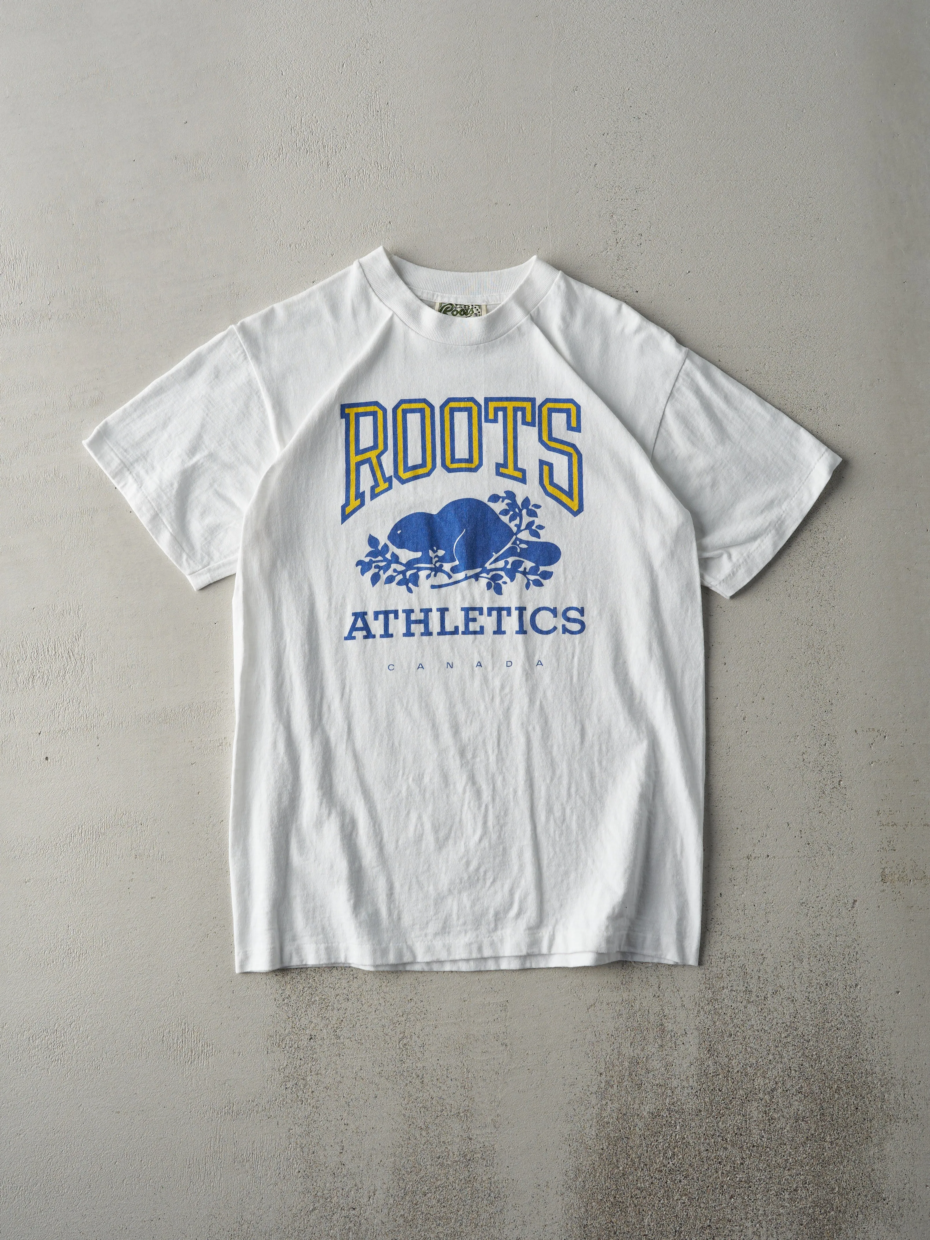 Vintage 90s White Roots Athletics Tee (S/M) sold by Rebalance Vintage