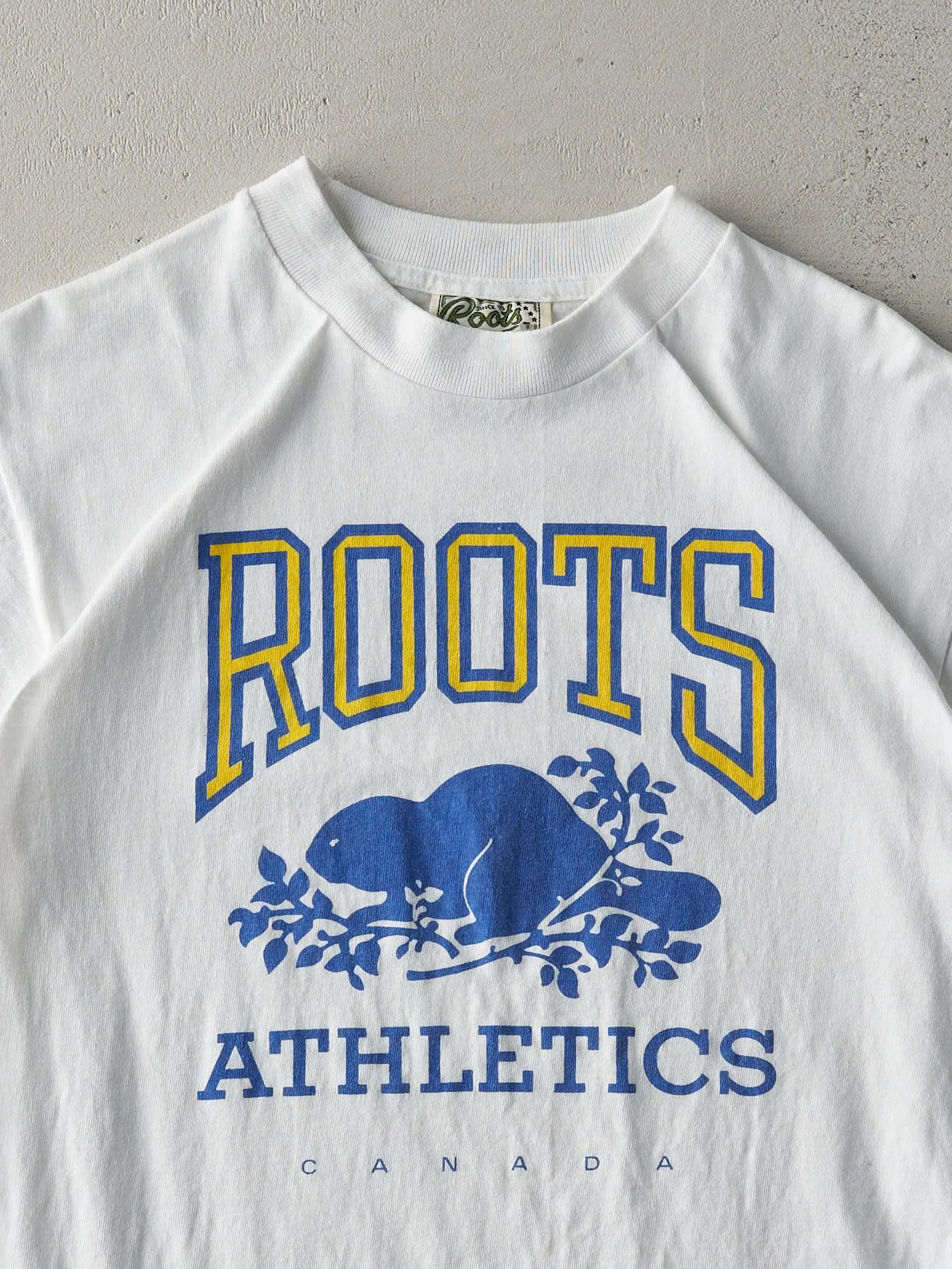 Vintage 90s White Roots Athletics Tee (S/M) sold by Rebalance Vintage product image thumbnail 2