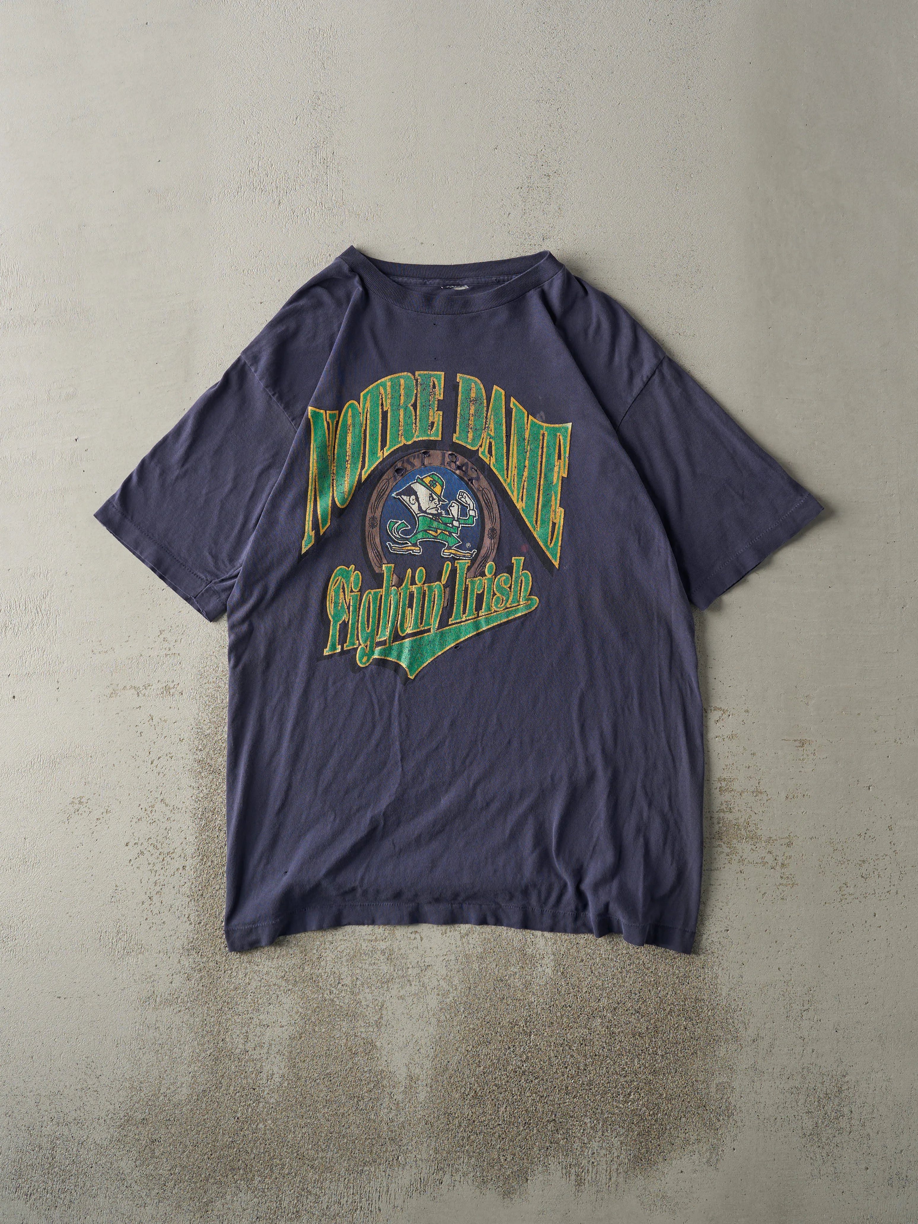 Vintage 90s Navy Blue Notre Dame Fighting Irish Single Stitch Tee (L/XL) sold by Rebalance Vintage