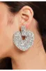 Liquorish Rhinestone Heart Shape Statement Earrings In Silver sold by Goddiva