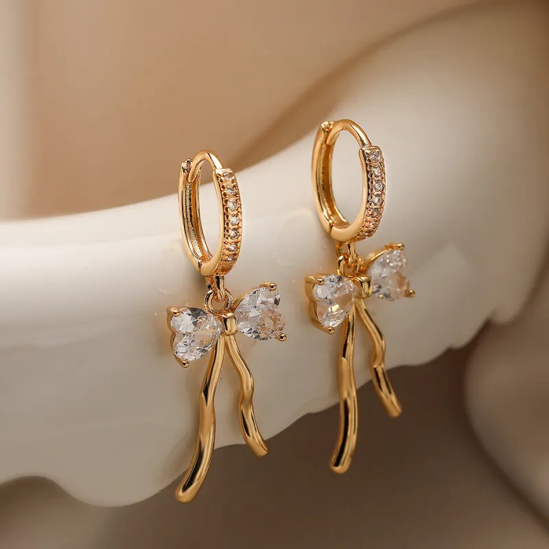 Cubic Zirconia Bow Pendant Huggie In Gold by Last True Angel sold by Goddiva