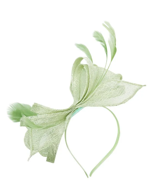 Bow Shaped Fascinator With Sinamay Curls & Feathers In Pastel Green by SVNX sold by Goddiva
