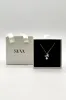 Dainty Bow Pearl Pendant Necklace by SVNX sold by Goddiva