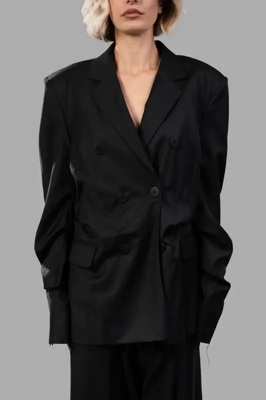 Insurance blazer in black wool‑blend sold by Plus Zero Concept Store