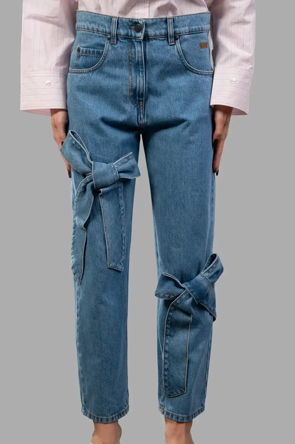 Wide‑leg trousers in blue washed denim sold by Plus Zero Concept Store