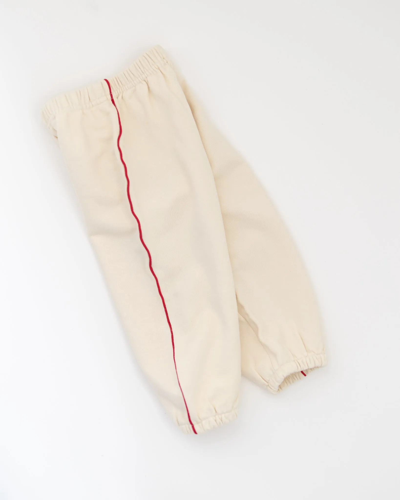 tiny red stripe joggers sold by Kindly