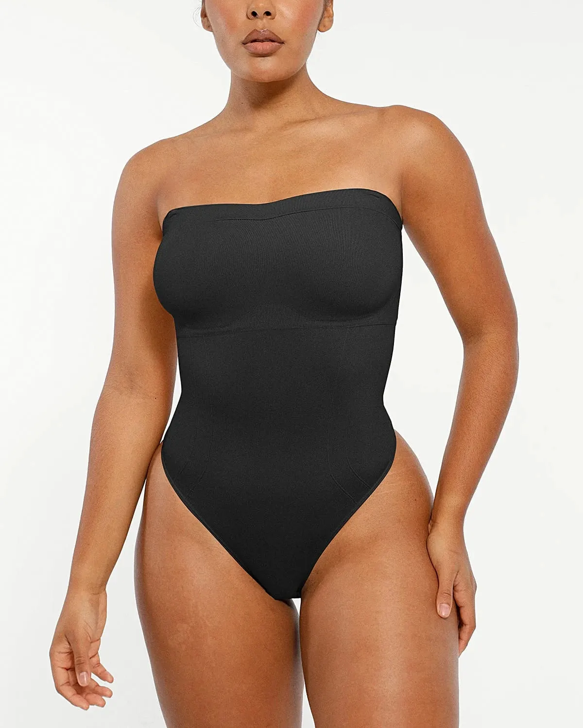 Bare Essentials™ Skin Flow™ Strapless Sculpt Thong Bodysuit sold by Shapellx