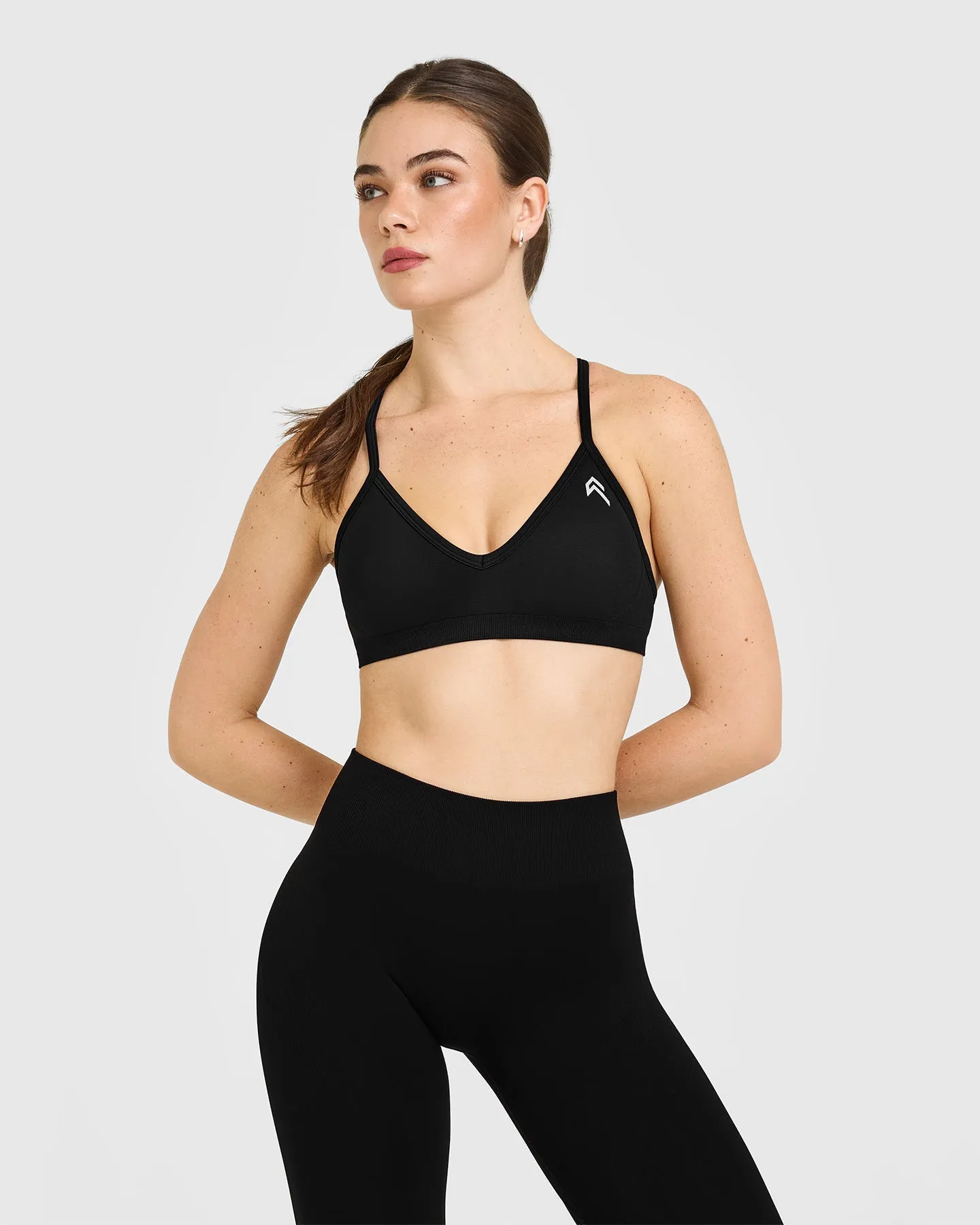 EnhanceLift™ Seamless Strappy Sports Bra with White Logo | Black sold by Oner Active