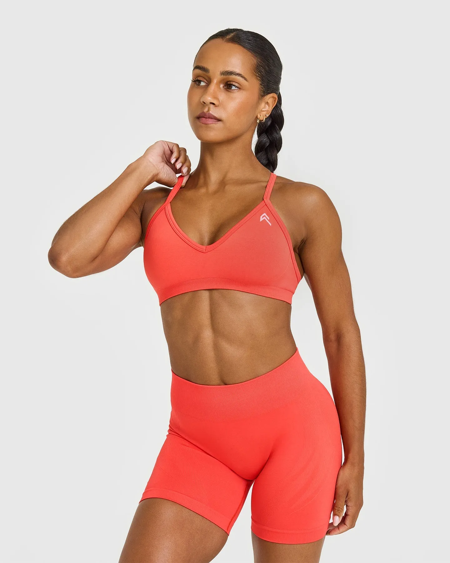 EnhanceLift™ Seamless Strappy Sports Bra with White Logo | Charged Coral sold by Oner Active