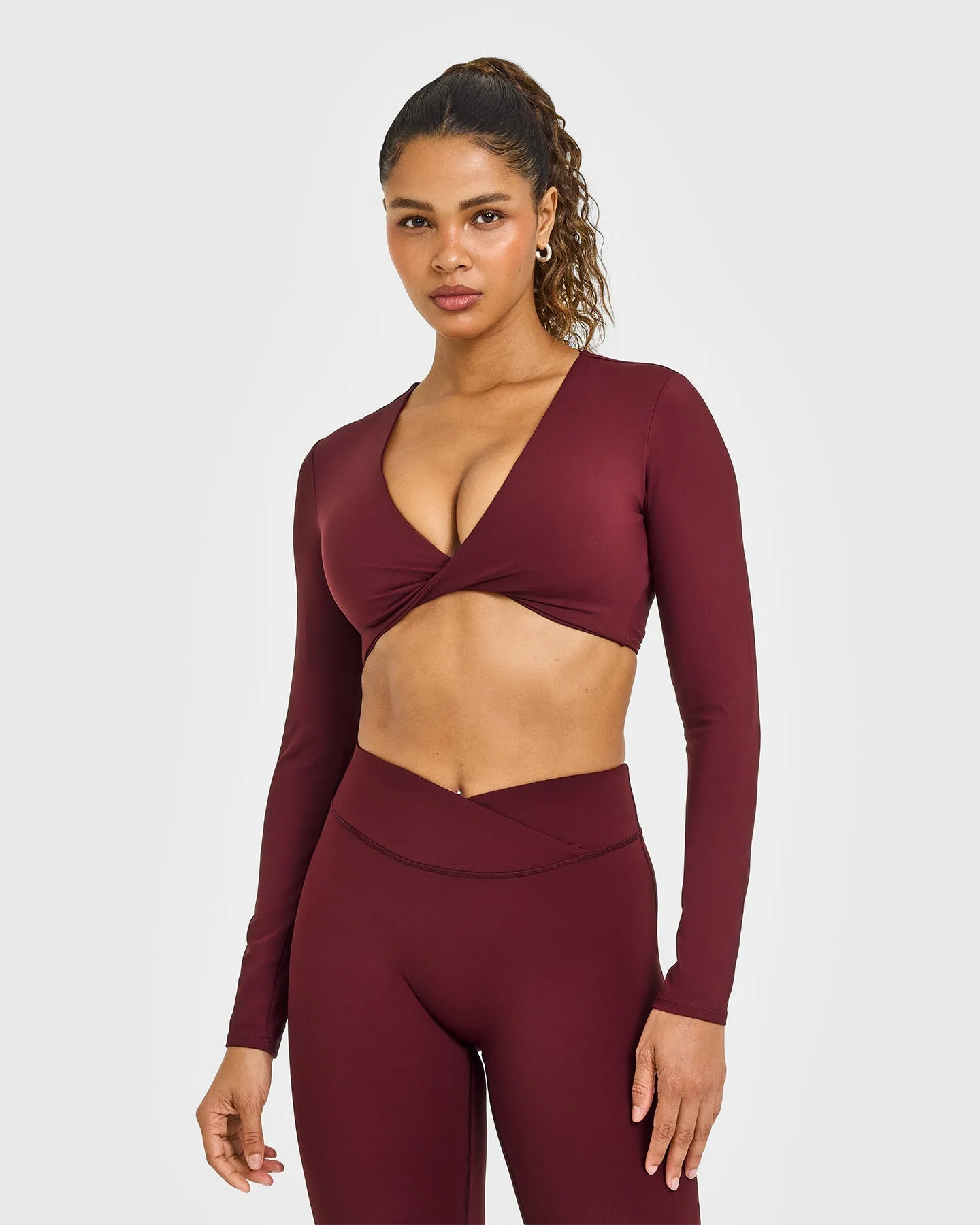 Unified Twist Front Long Sleeve Crop Top White Logo | Rosewood sold by Oner Active