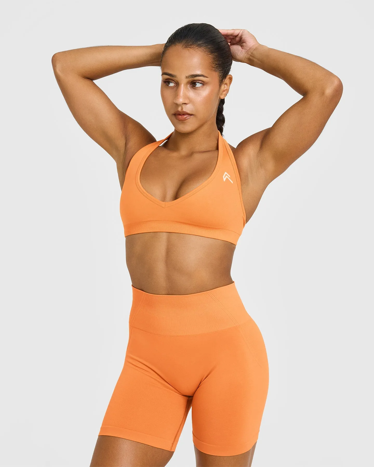 Effortless Seamless Halter Neck Sports Bra with White Logo | Apricot Orange sold by Oner Active