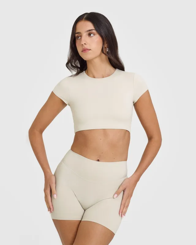 SoftMotion™ Short Sleeve Crop Top with White Logo | Sand sold by Oner Active