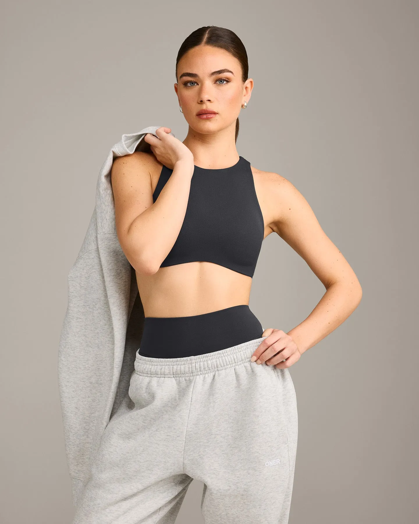 SoftMotion™ High Neck Sports Bra with Grey Logo | Coal sold by Oner Active
