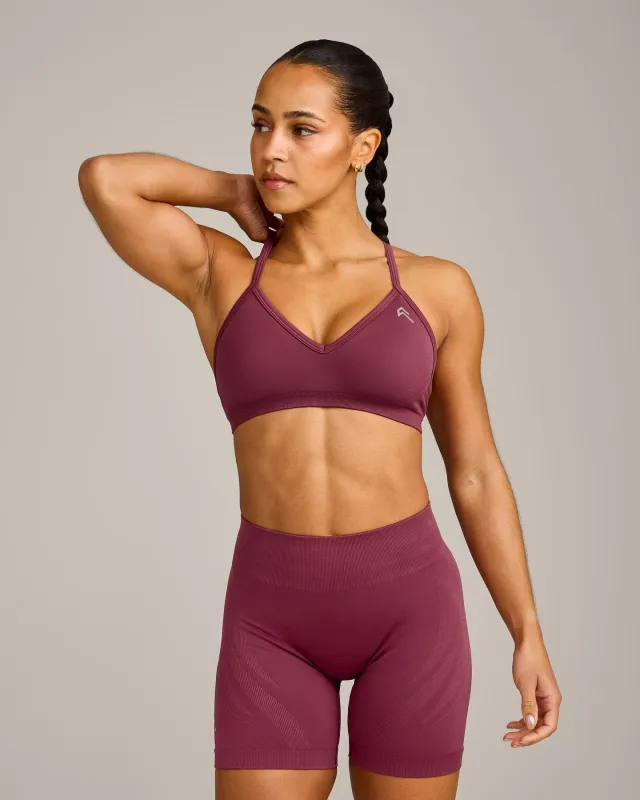 EnhanceLift™ Seamless Strappy Sports Bra with Grey Logo | Burnt Maroon made by Oner Active