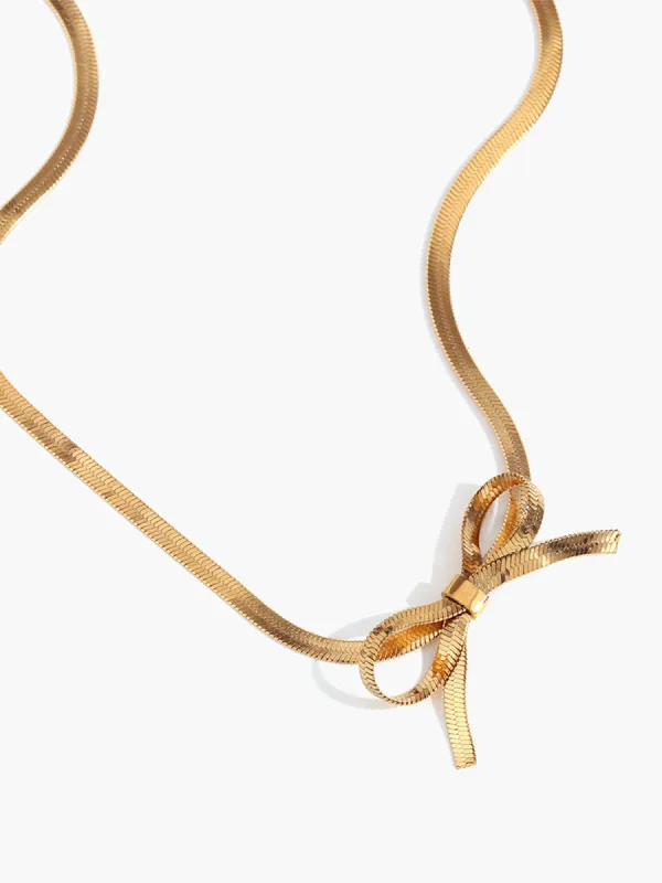 Gold Bow Necklace sold by COMMENSE