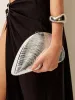 Metallic Shell Clutch sold by COMMENSE