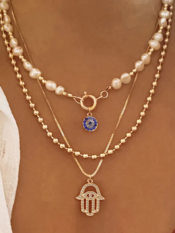 Pearl & Hamsa Hand Multi-Layer Necklace Set sold by COMMENSE