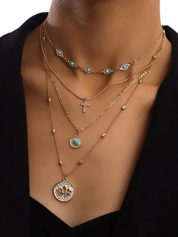 Layered Gold Tone Necklace with Turquoise and Charms sold by COMMENSE