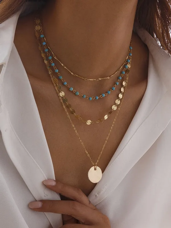 Gold-Tone Layered Necklace with Beads and Disc Pendant sold by COMMENSE