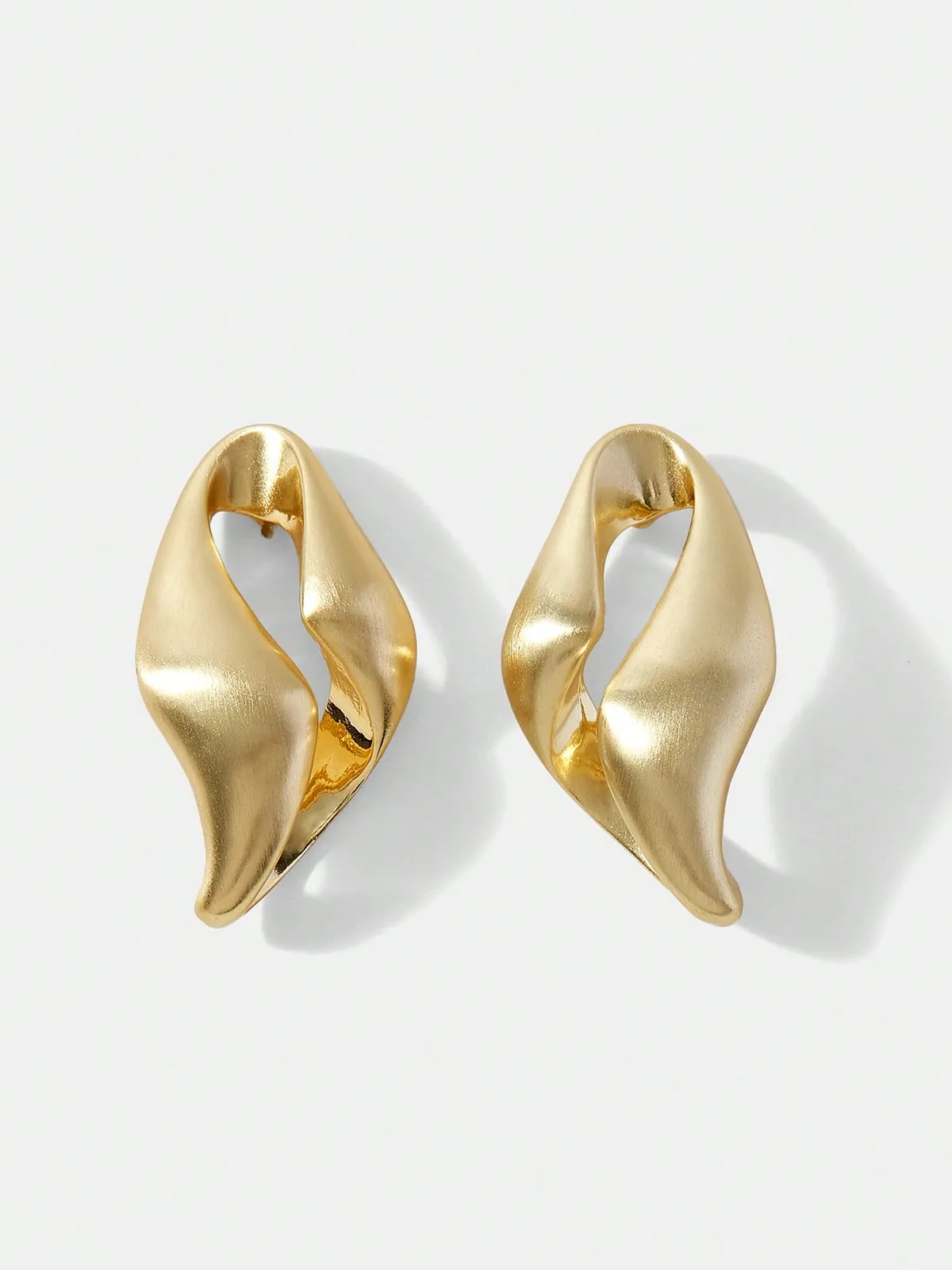 Twisted Sculptural Hoop Earrings sold by COMMENSE