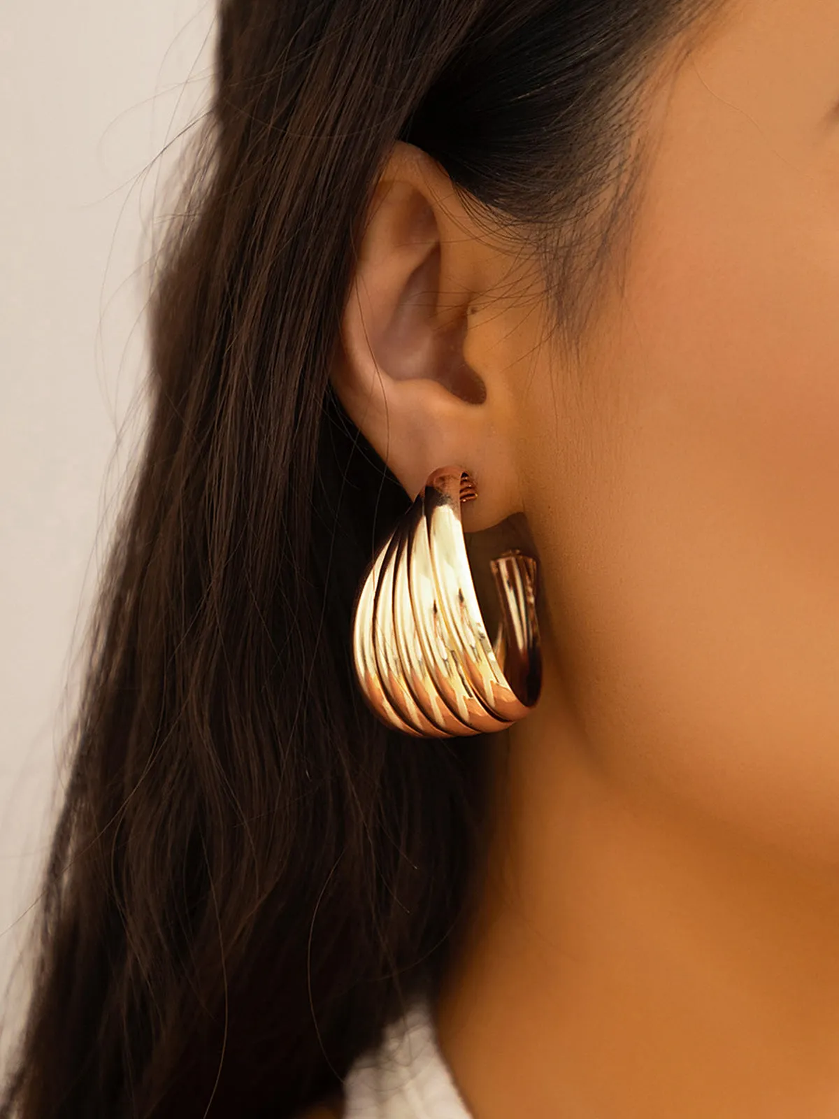 Sculpted Gold-Tone Swirl Hoop Earrings sold by COMMENSE