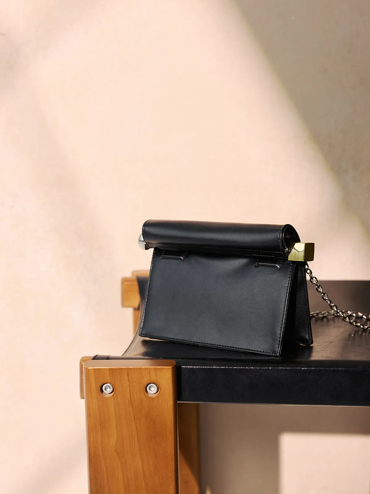 Metal Accent Roll-Top Clutch Bag sold by COMMENSE