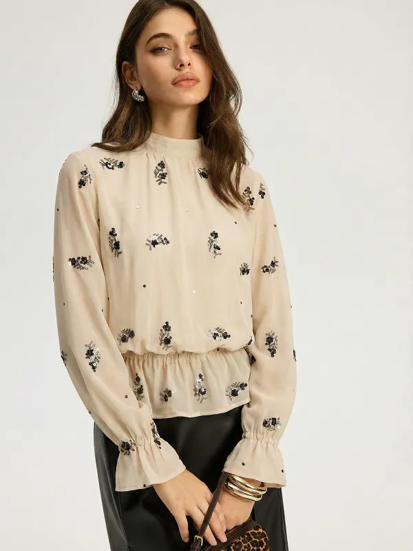 Sequin Floral Mock Neck Smocked Waist Blouse sold by COMMENSE