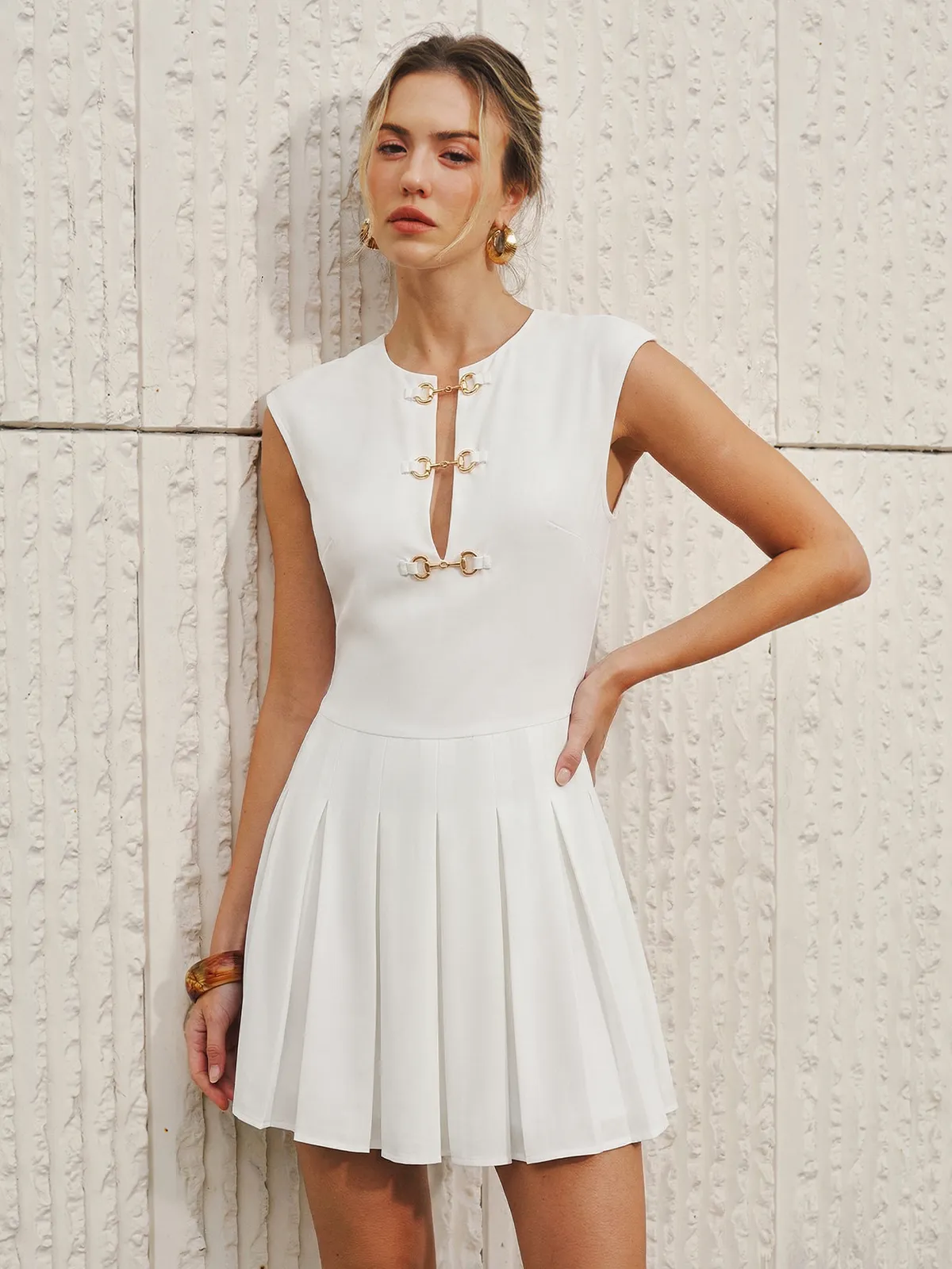 Sleeveless Horsebit Pleated Mini Dress sold by COMMENSE