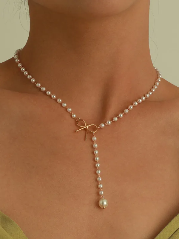 Pearl Bow Knot Pendant Necklace sold by COMMENSE