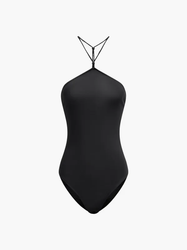 Solid Halter Open Back Bodysuit sold by COMMENSE