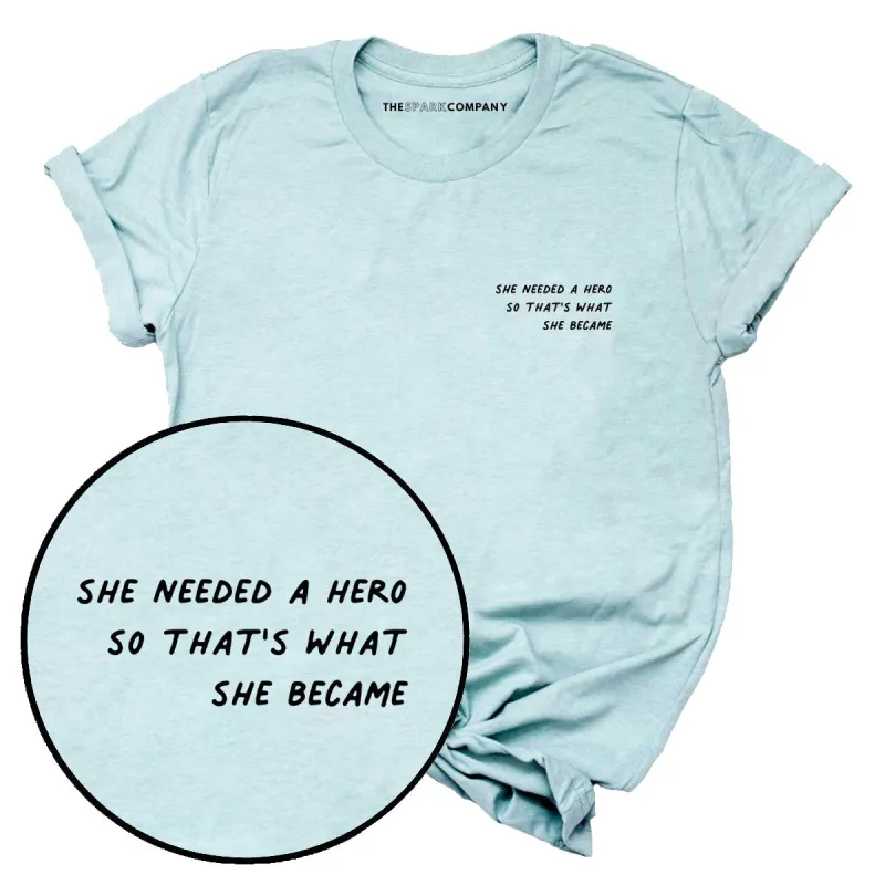 She Needed A Hero So That's What She Became T-Shirt sold by The Spark Company