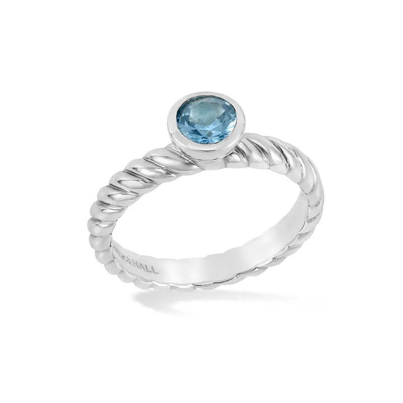 5mm Blue Topaz Twist Twinkle Ring sold by Dower & Hall