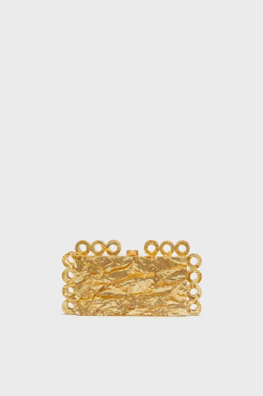 Gold Harlow Clutch sold by Tuckernuck