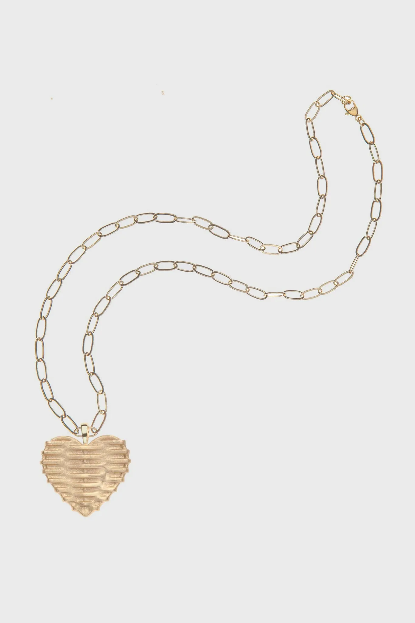 Woven with LOVE Heart Pendant sold by Tuckernuck