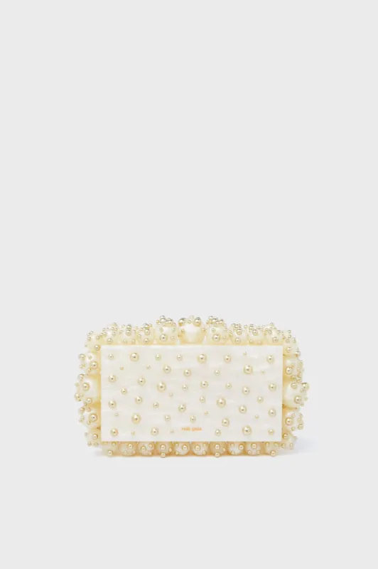 Ivory and Shiny Brass Eos Clutch sold by Tuckernuck