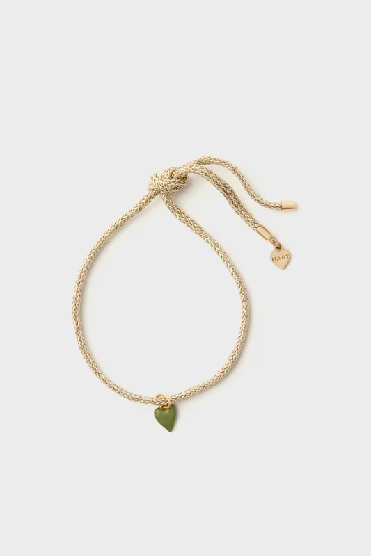 Gold Lurex Cord Bracelet with Mini Green Enamel Heart sold by Tuckernuck